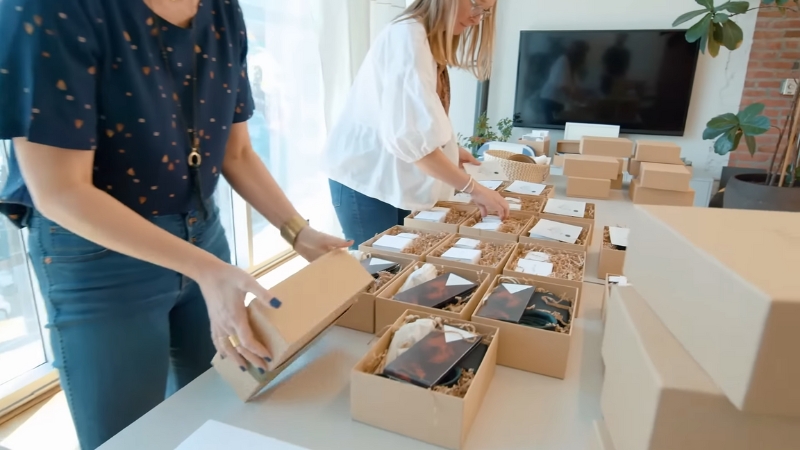 Women assembling curated gift boxes on a table as part of premium corporate gift ideas