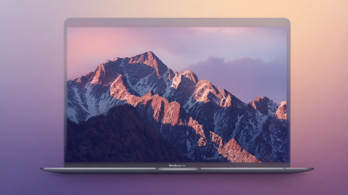 Portátil con pantalla mostrando una montaña al atardecer y fondo en tonos suaves