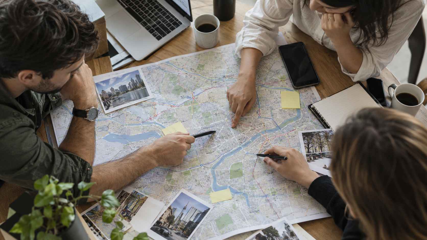 Coworkers reviewing a city map to choose a hub office location.
